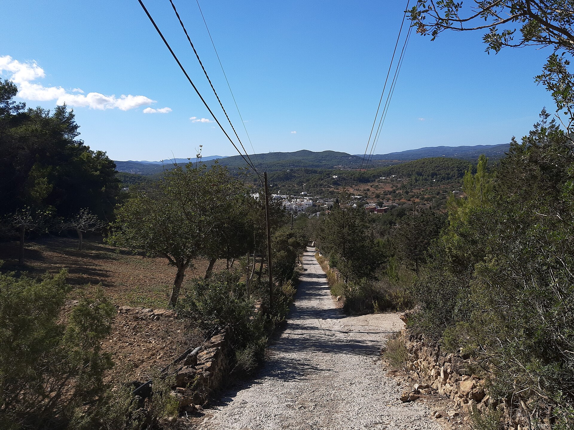 Landschap rond Sant Carles met afdaling naar het dorp