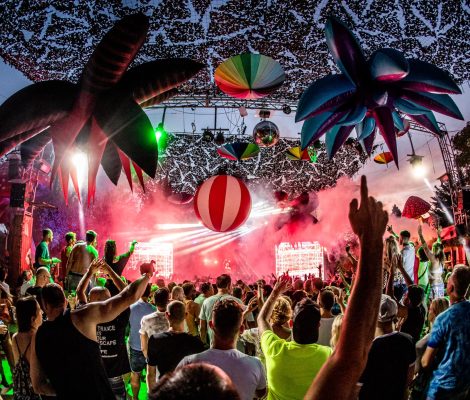 Open-air dansvloer van Benimussa Park (The Zoo Project) op Ibiza met opblaaspalmen, discobal en menigte