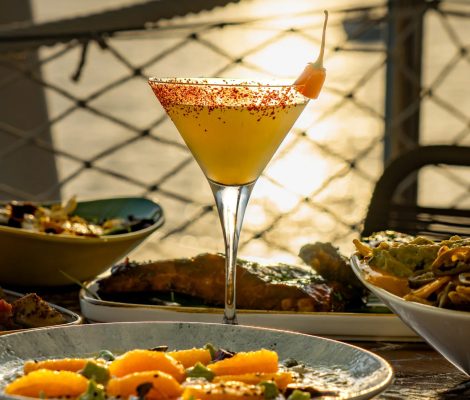 Cocktail met zonsondergang over zee bij Savannah op de Sunset Strip, San Antonio, Ibiza