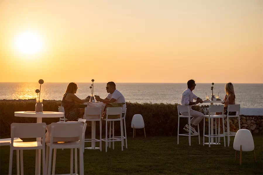Hoge tafels op het klifterras van Eolo Sunset Bar met zicht op zee