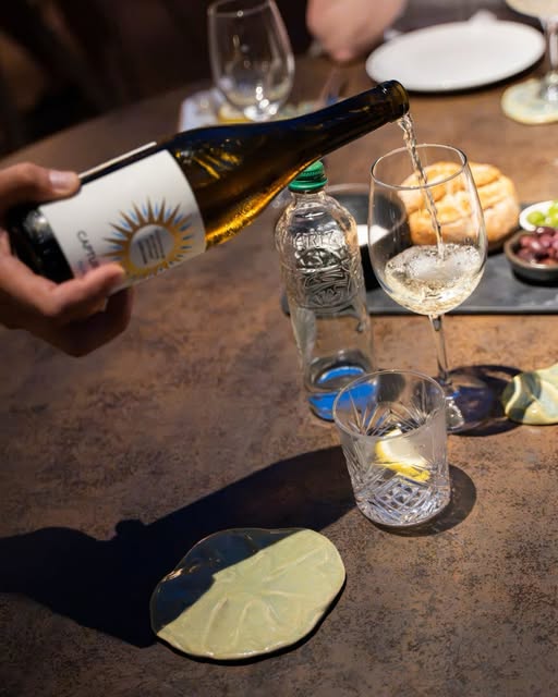 Wijn wordt ingeschonken aan een gedekte tafel bij Es Mal Pas