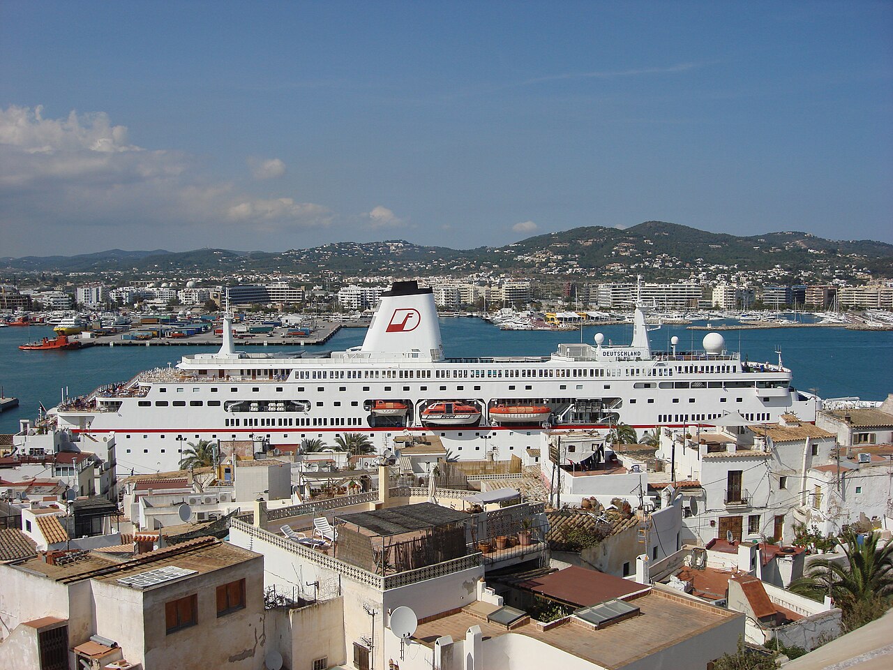 Een cruiseschip aan de kade boven de daken van Ibiza-stad