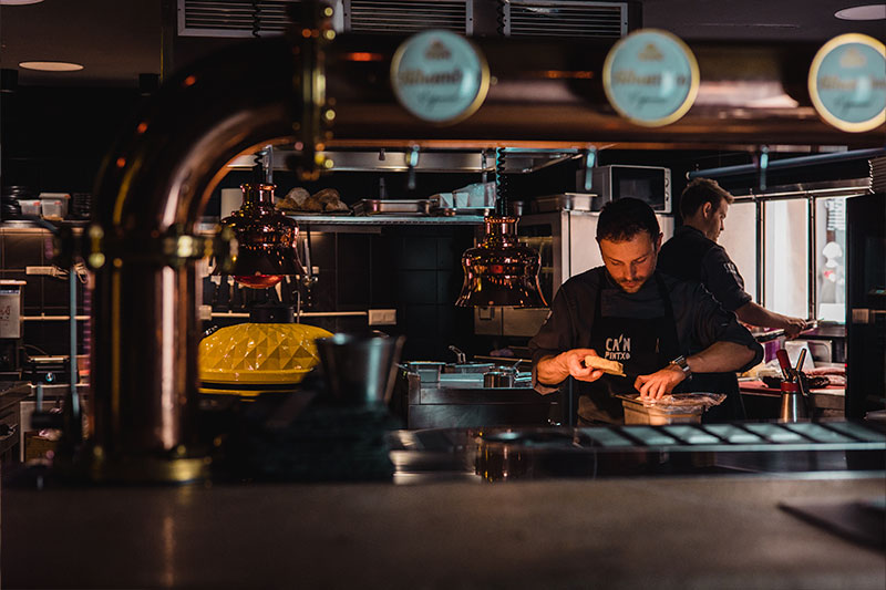 Ca'n Pintxo Sóller: Baskische hapjes van Mallorcaanse grond 6 Koks aan het werk in de open keuken van Ca'n Pintxo in Sóller, gezien vanaf de bar achter de koperen biertap