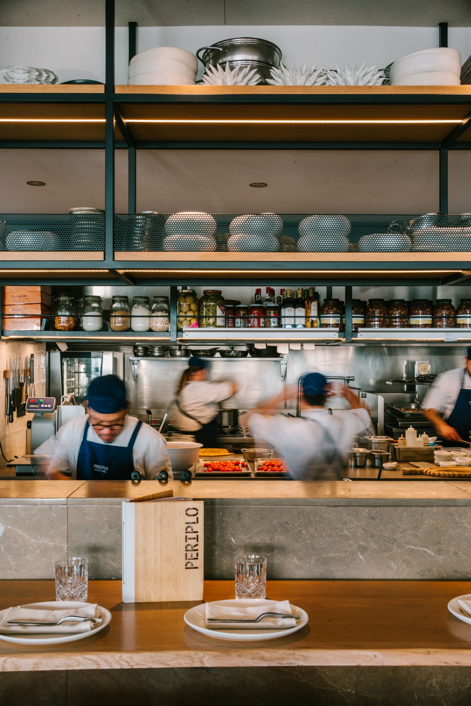 Periplo Portixol (Palma): vis van de grill aan het water in es Molinar 2 De open keuken van Periplo Portixol achter de bar, met koks aan het werk en planken vol borden en weckpotten