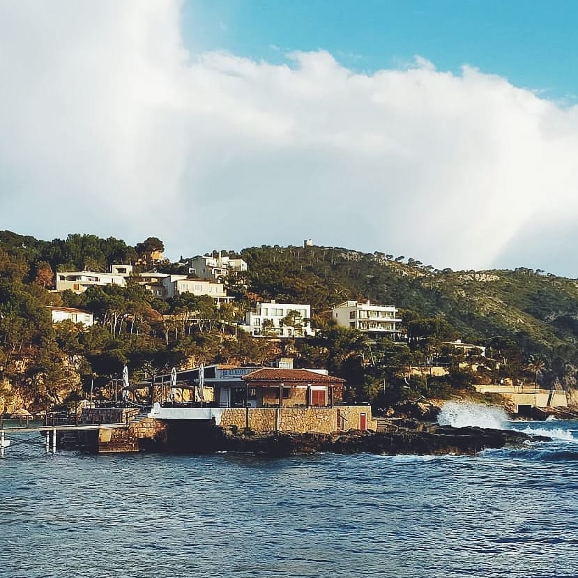 Restaurante Illeta Mallorca: eten op een rotseilandje bij Camp de Mar 4 Restaurante Illeta op het rotseilandje vanaf zee gezien, met de villa's tegen de beboste helling erachter